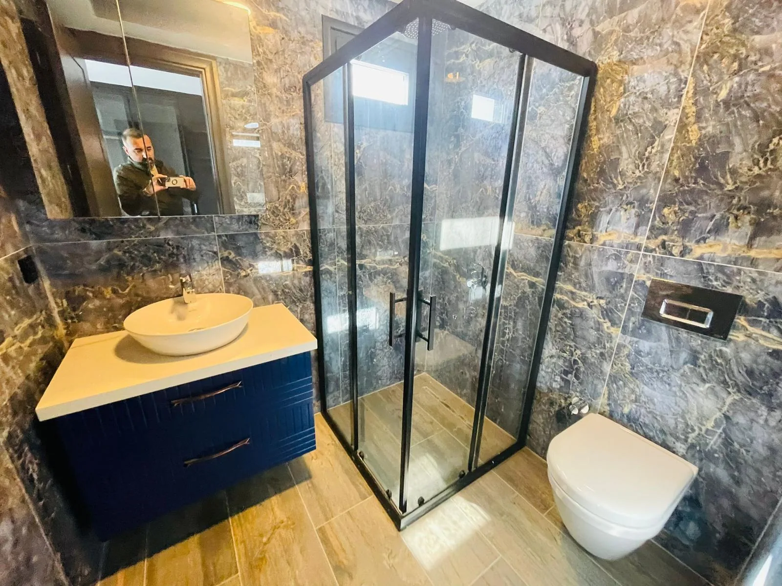 Bathroom with shower and blue vanity